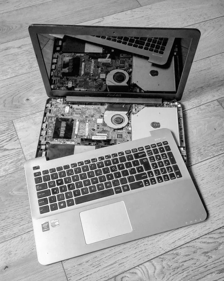 Laptop with the bottom panel removed for hardware repair