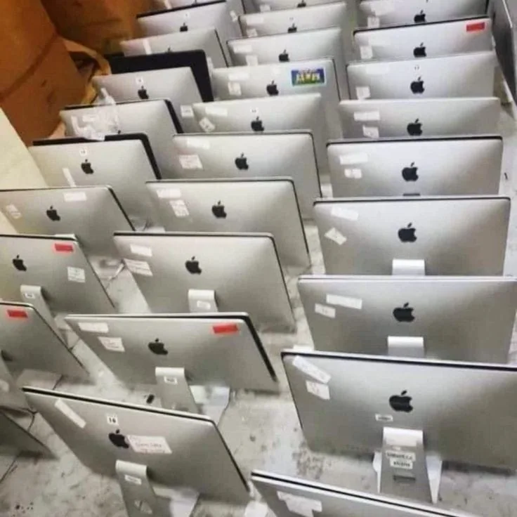 Rows of refurbished MacBooks in stock at Renew Laptop in Ahmedabad